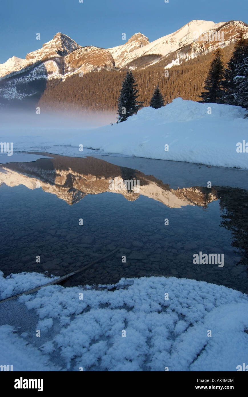 CANADA Alberta Banff National Park Lake Louise morning fog rises off ...
