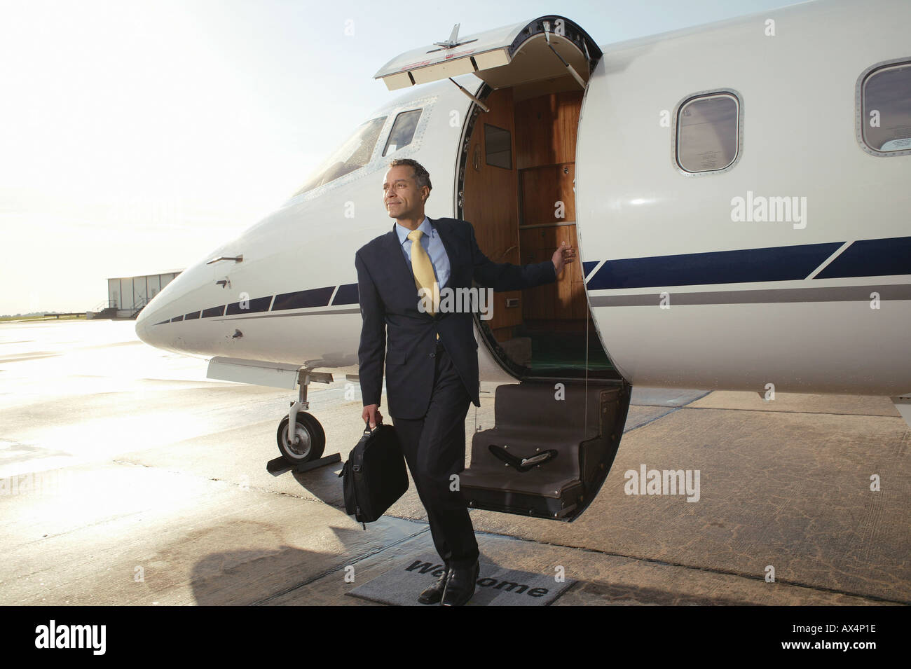 Businessman boarding a private airplane Stock Photo