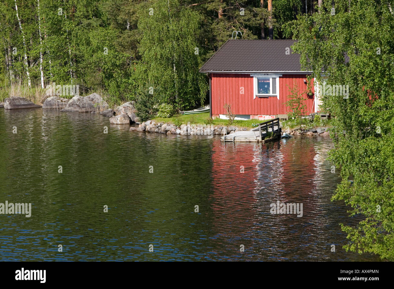 Small red sauna cabin at lake shore  , Finland Stock Photo