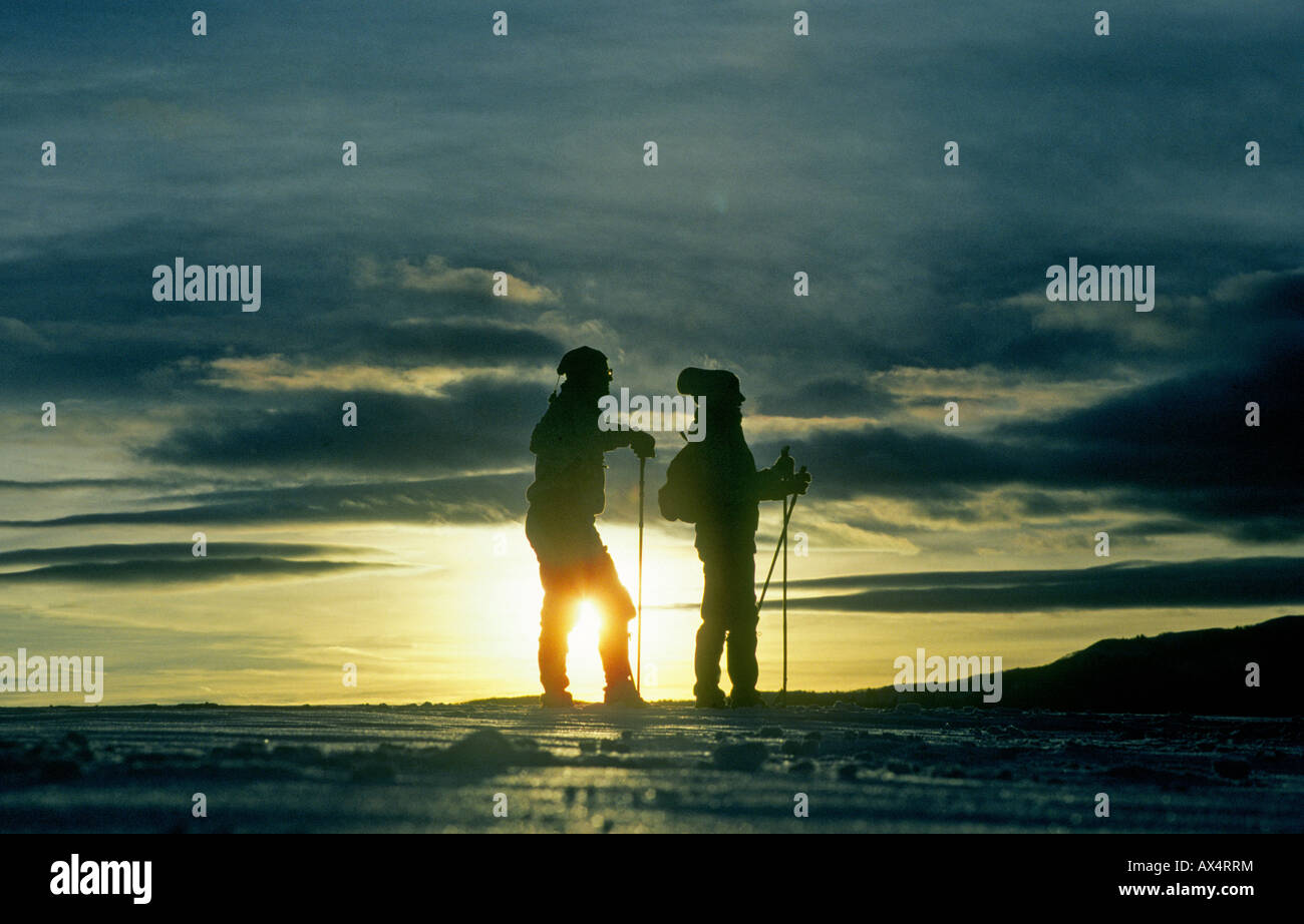 Cross country skiers at sunset in deep snow in the mountains near Camp Sherman Stock Photo