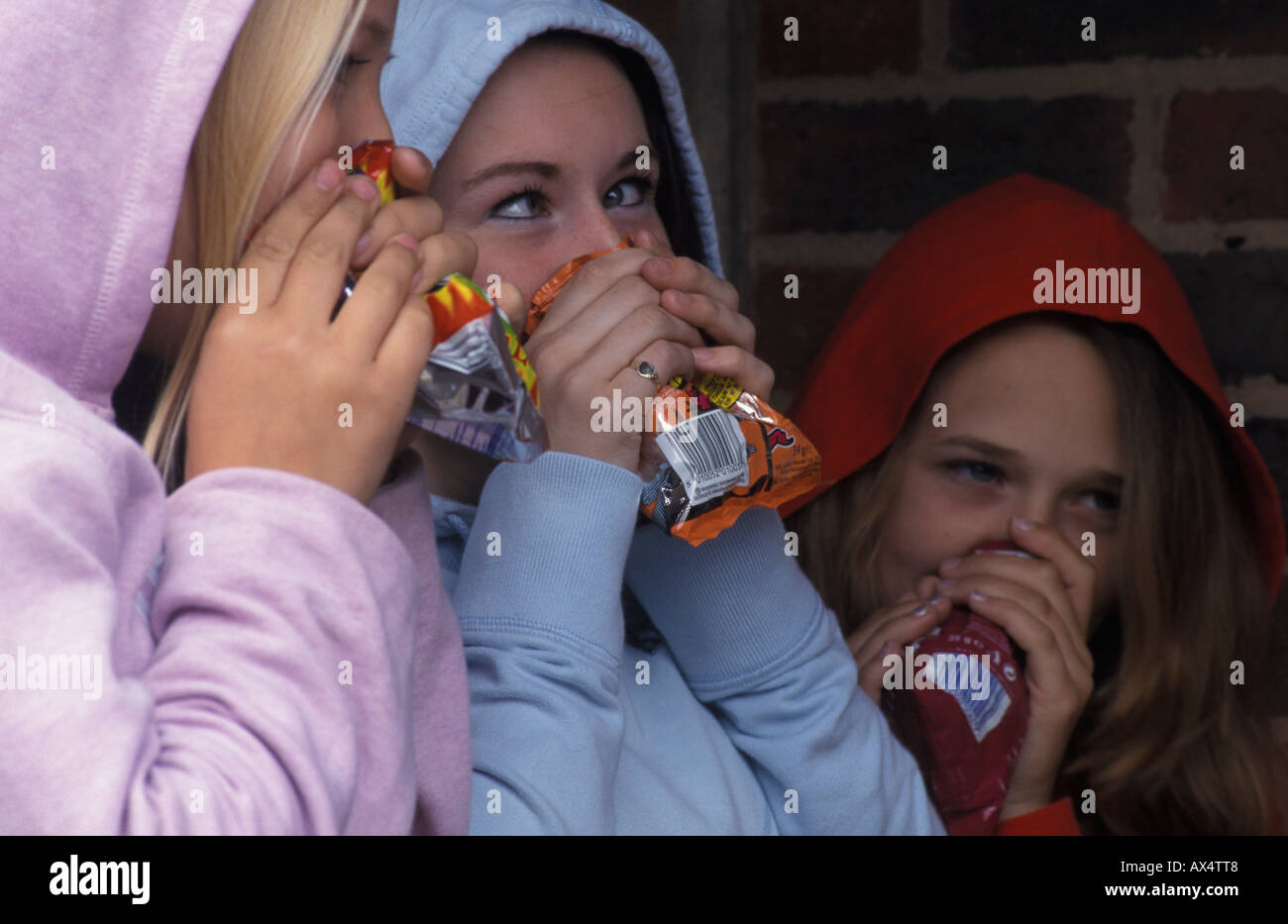 children sniffing glue from empty crisp packets Stock Photo 9559687
