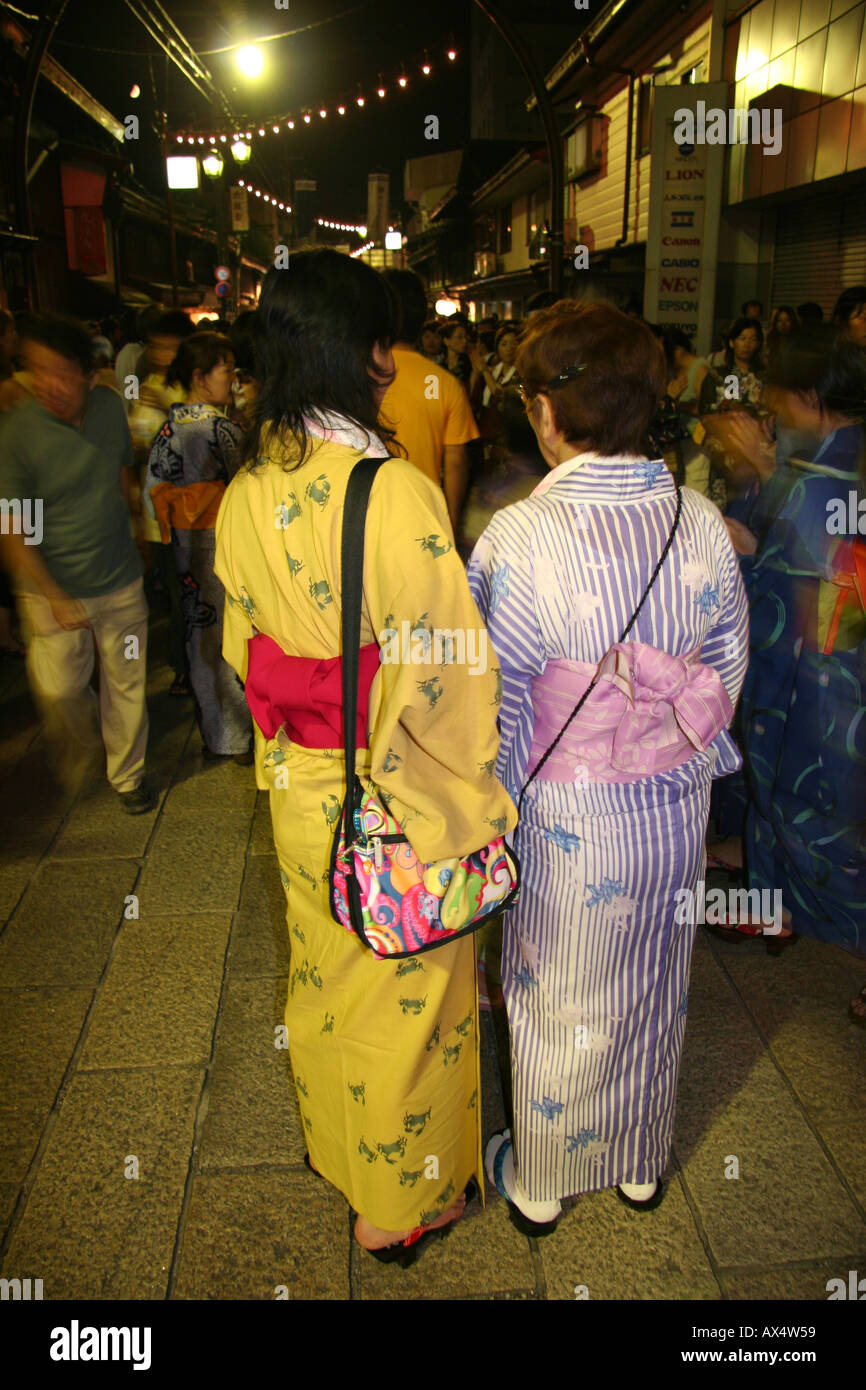 Women in yukata (summer cotton kimono) at an o-bon festival for the dead in Japan Stock Photo