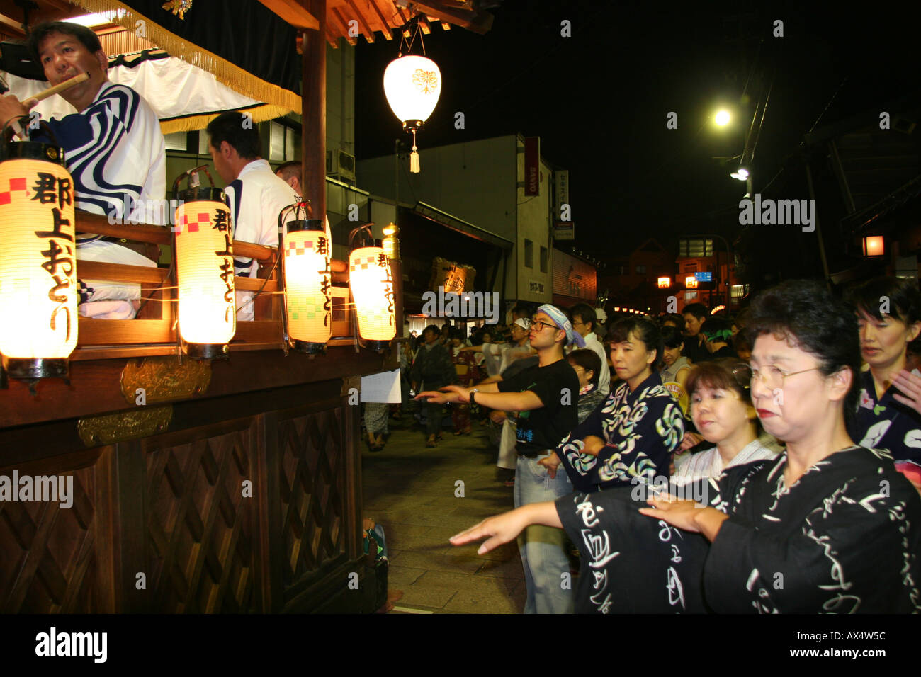 People in yukata dancing at an o-bon festival for the dead in Japan Stock Photo
