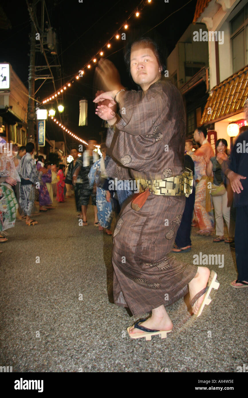 Man in yukata dancing at an o-bon festival for the dead in Japan Stock Photo