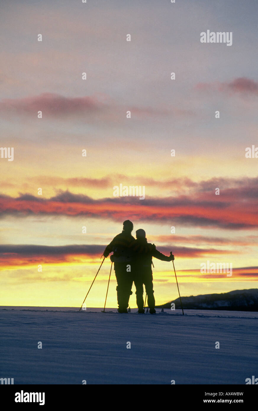 Cross country skiers at sunset in the mountains near Camp Sherman Stock Photo