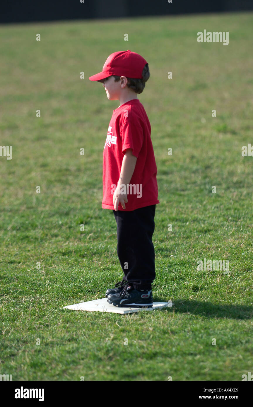 baseball boy standing on base Stock Photo Alamy