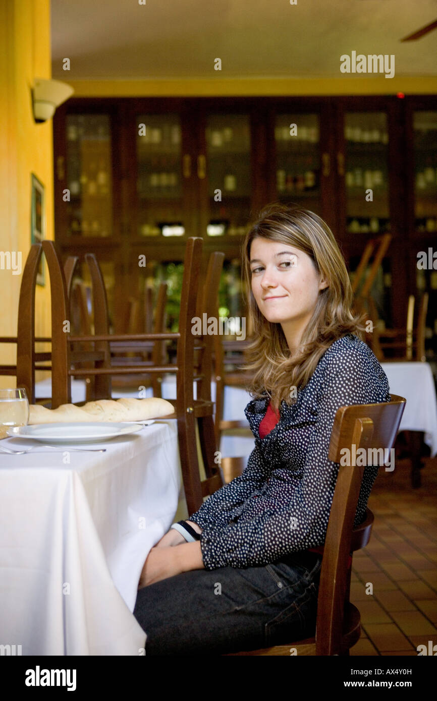 young woman eating in a restaurant Stock Photo