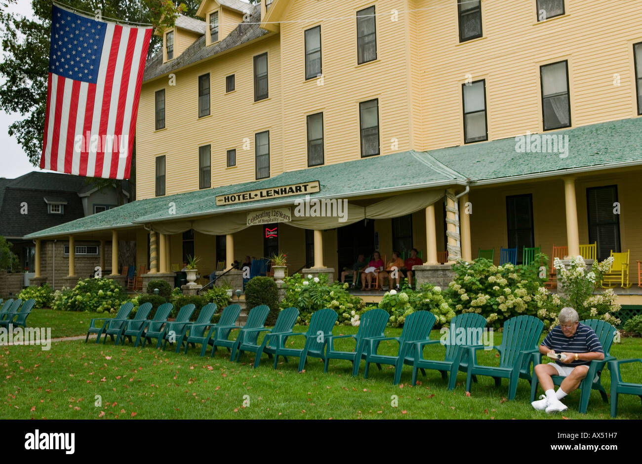 Green Adirondack chairs in a line Hotel Lenhart, Bemus Point Lake