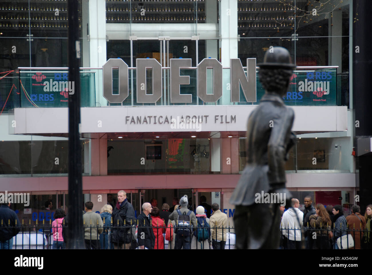 Statue of Charlie Chaplin overlooking fans outside film premiere at the Odeon Leicester Square, London Stock Photo