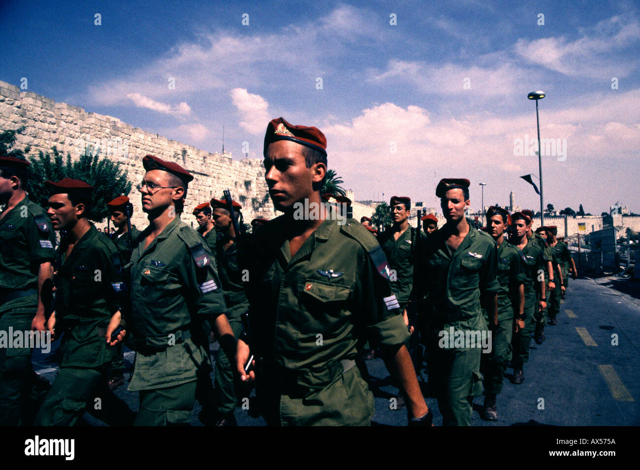 Israeli soldiers of the 35th Brigade also known as the Paratroopers Brigade parade in front of old city walls during Jerusalem day celebrations Stock Photo
