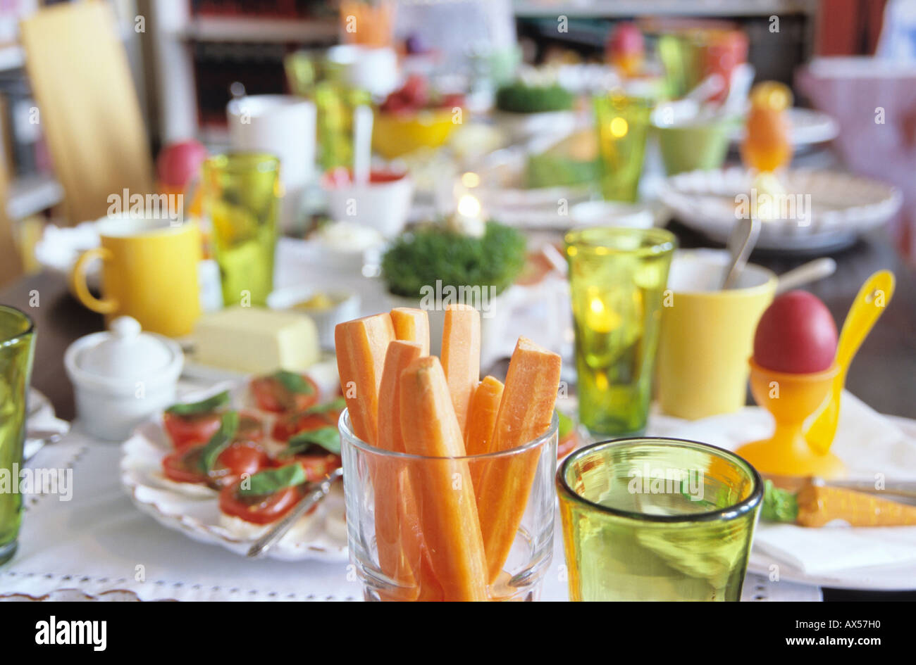 Easter table setting, focus on carrot slices in glass Stock Photo