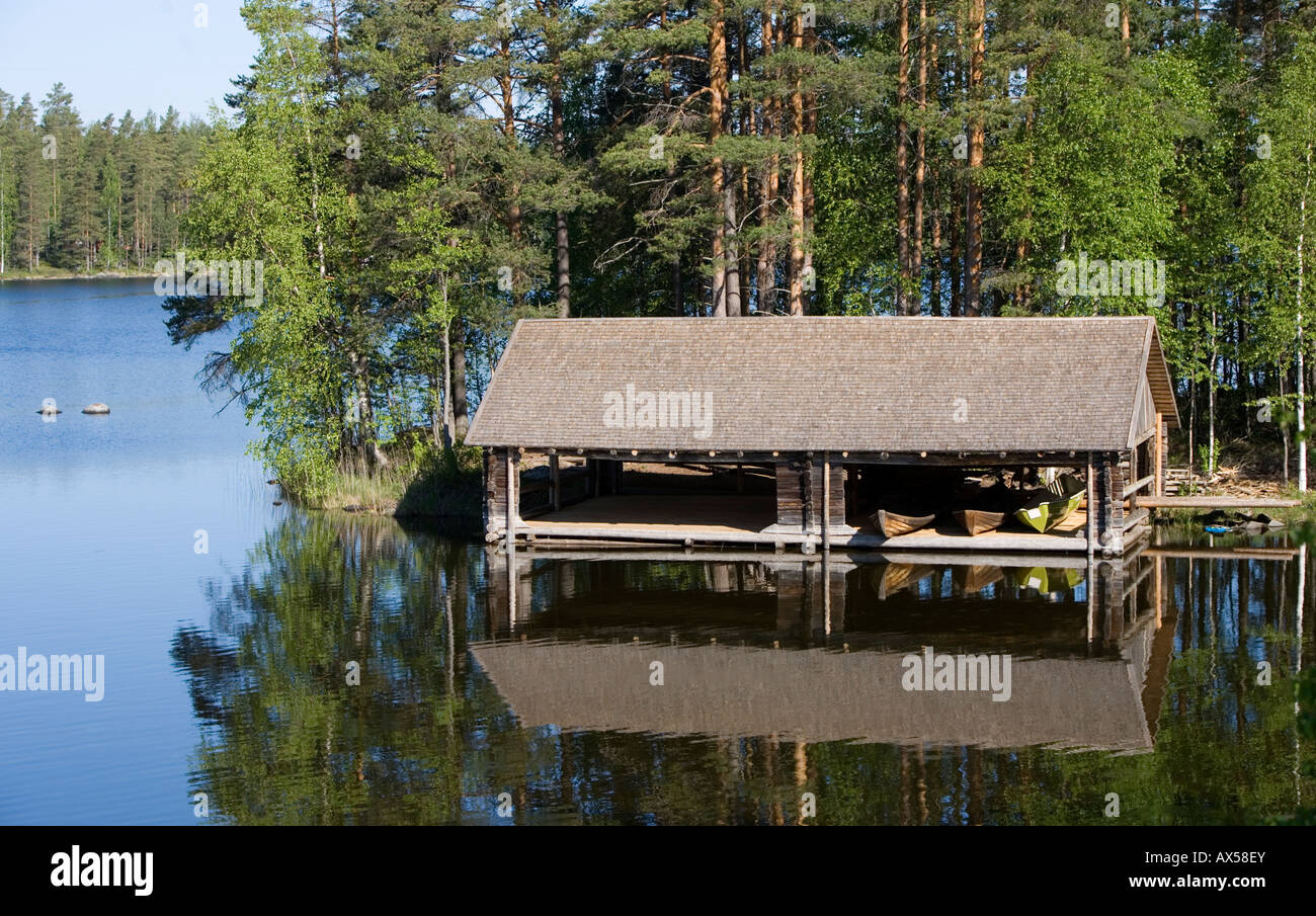 Wooden old-fashioned boathouse for rowboats and skiffs and dinghies  / dinghy at lake Konnevesi Finland Stock Photo