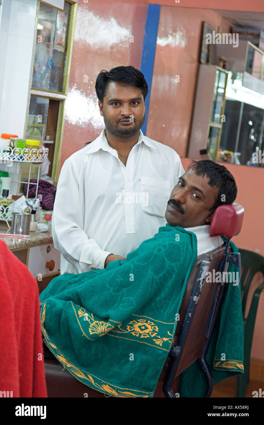 Traditional barber with customer in chair Muscat Oman Stock Photo Alamy