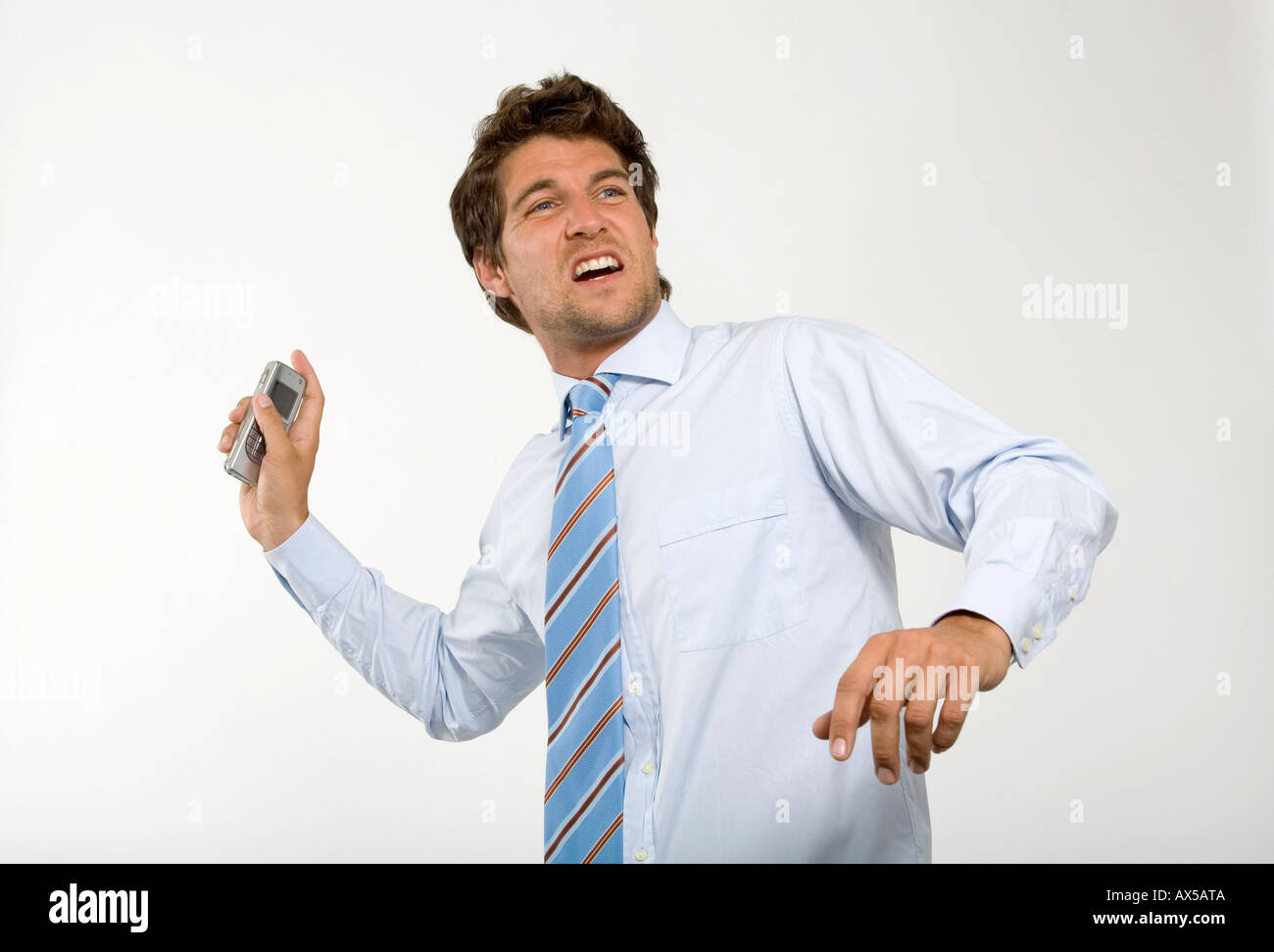 Young businessman throwing mobile phone, closeup Stock Photo 9562377