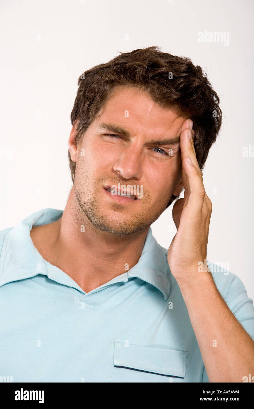 Young man with head in hands, close-up, portrait Stock Photo