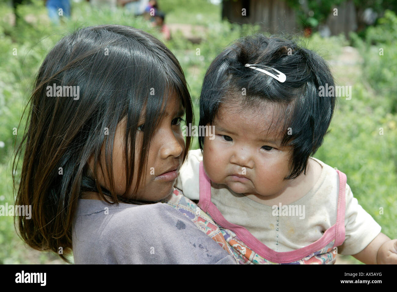 Girl with child on her arms, Nivaclé Indians, Jothoisha, Chaco, Paraguay, South America Stock Photo