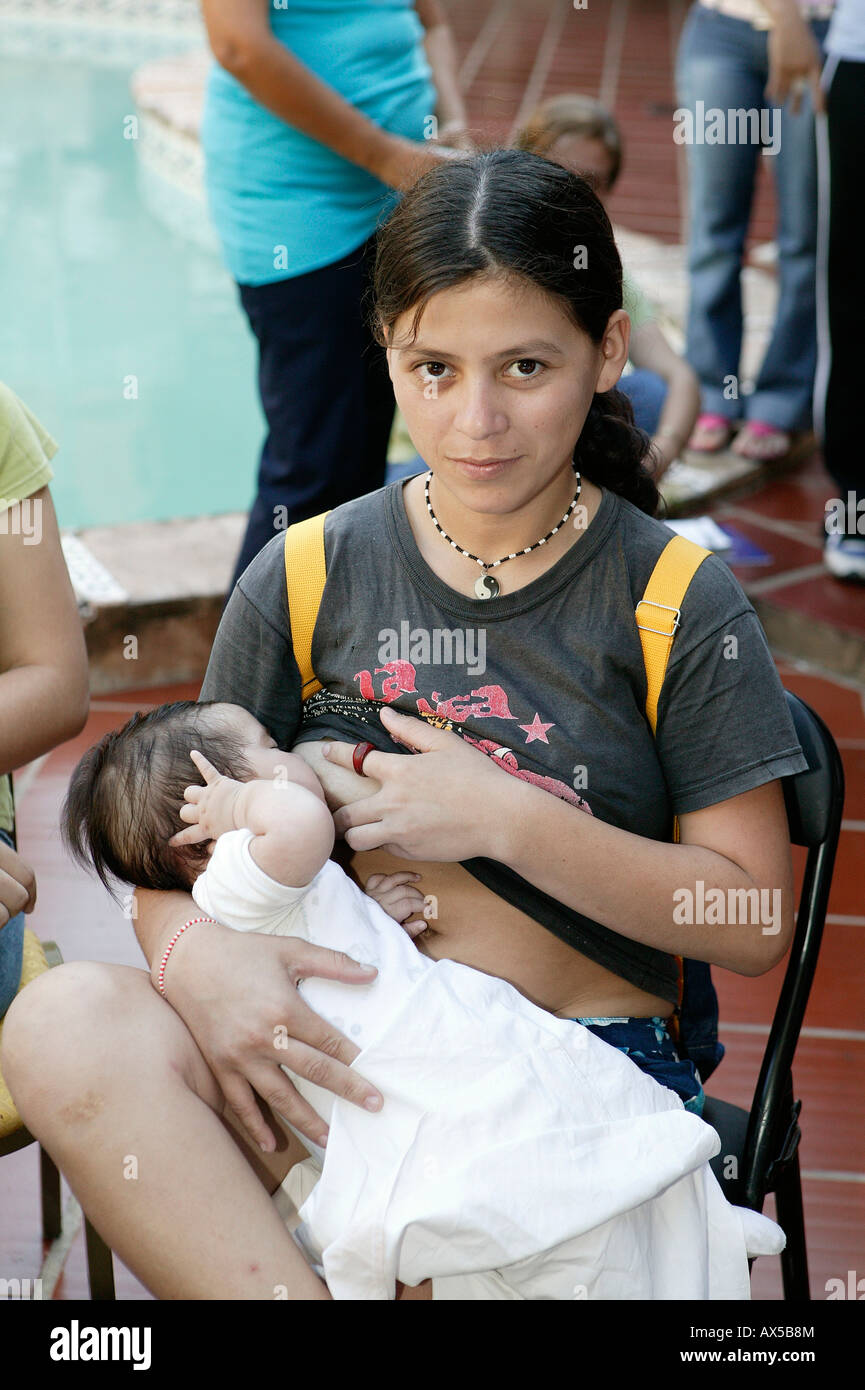 Young girl breast-feeding her baby, Asuncion, Paraguay, South