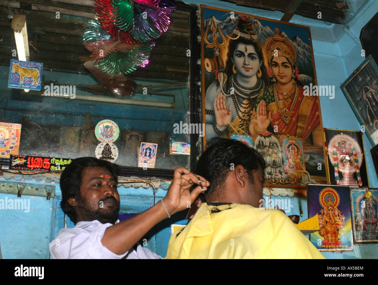 Hindu Barber shop with deity images displays in Madurai , Tamil Nadu