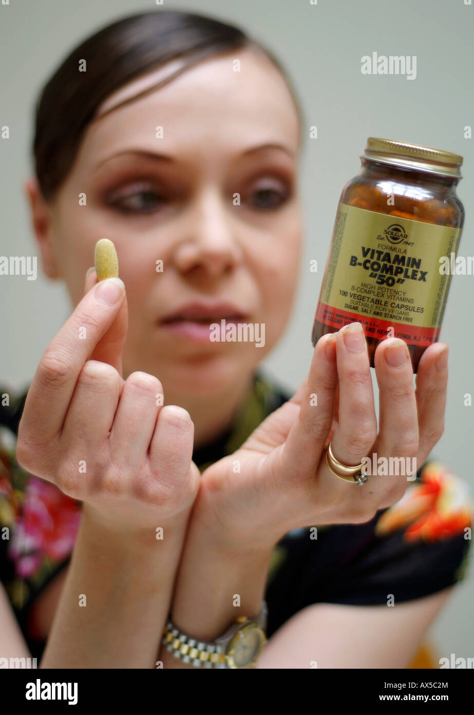 A young woman taking dietary supplements Stock Photo Alamy