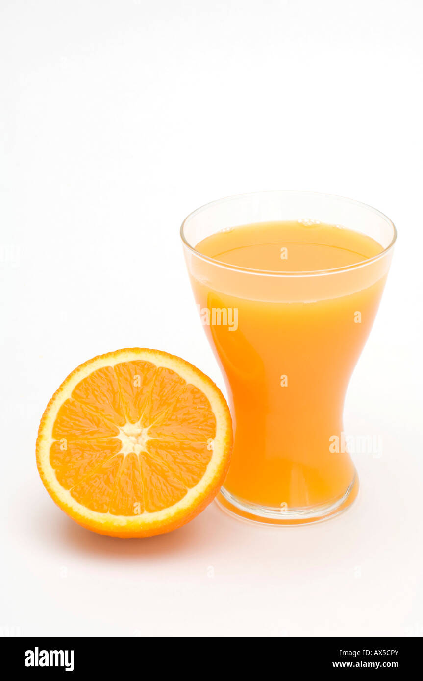 Glass of orange juice and an orange half Stock Photo