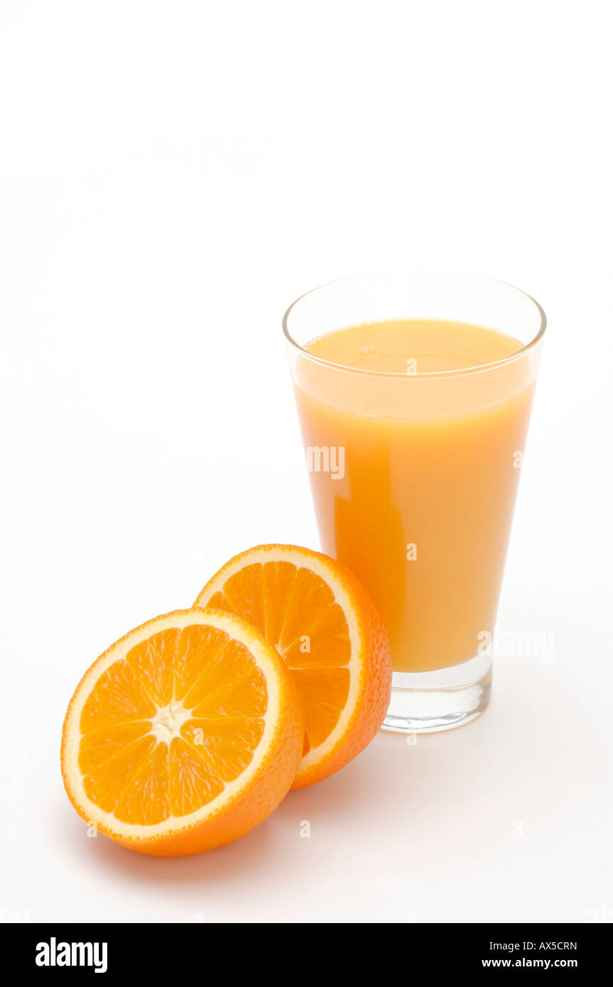 Glass of orange juice and orange halves Stock Photo