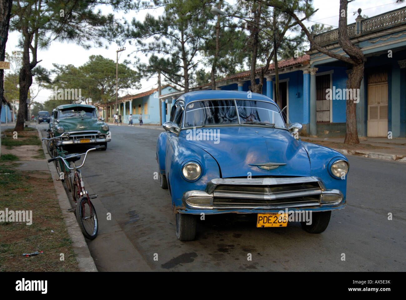 Blue vintage car driving down a street in Vinales, Cuba, Caribbean Stock Photo