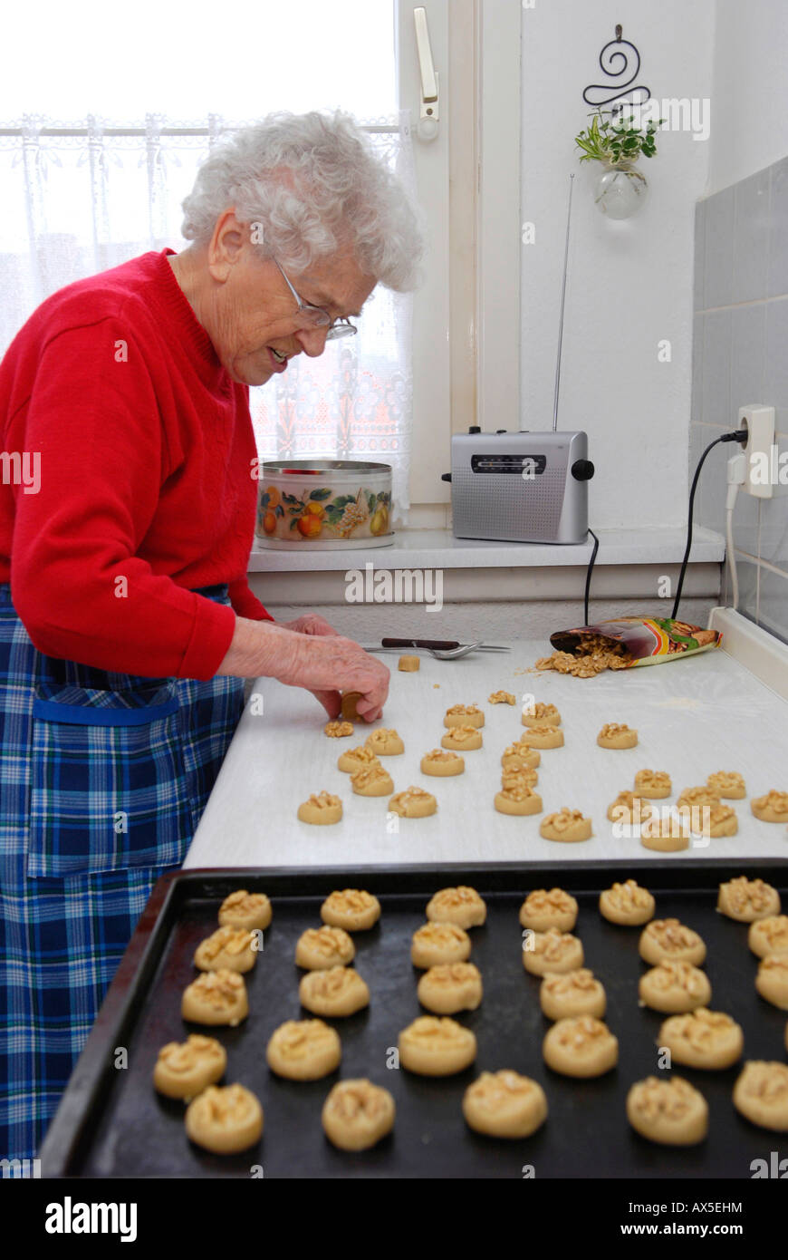 Old woman baking cookies Stock Photo