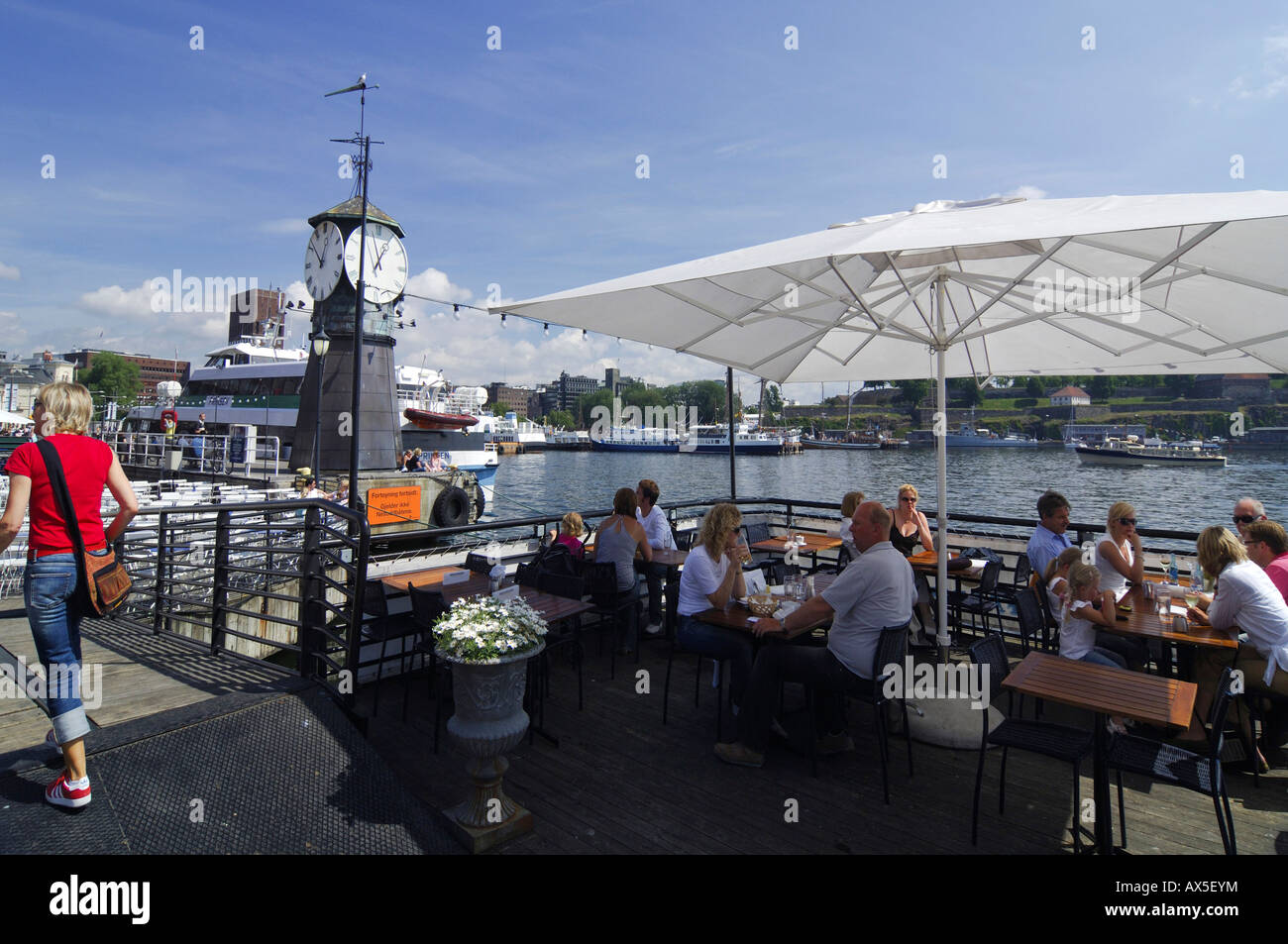 Clock tower and restaurant at the Aker Brygge shopping mall, Oslo, Norway, Scandinavia, Europe
