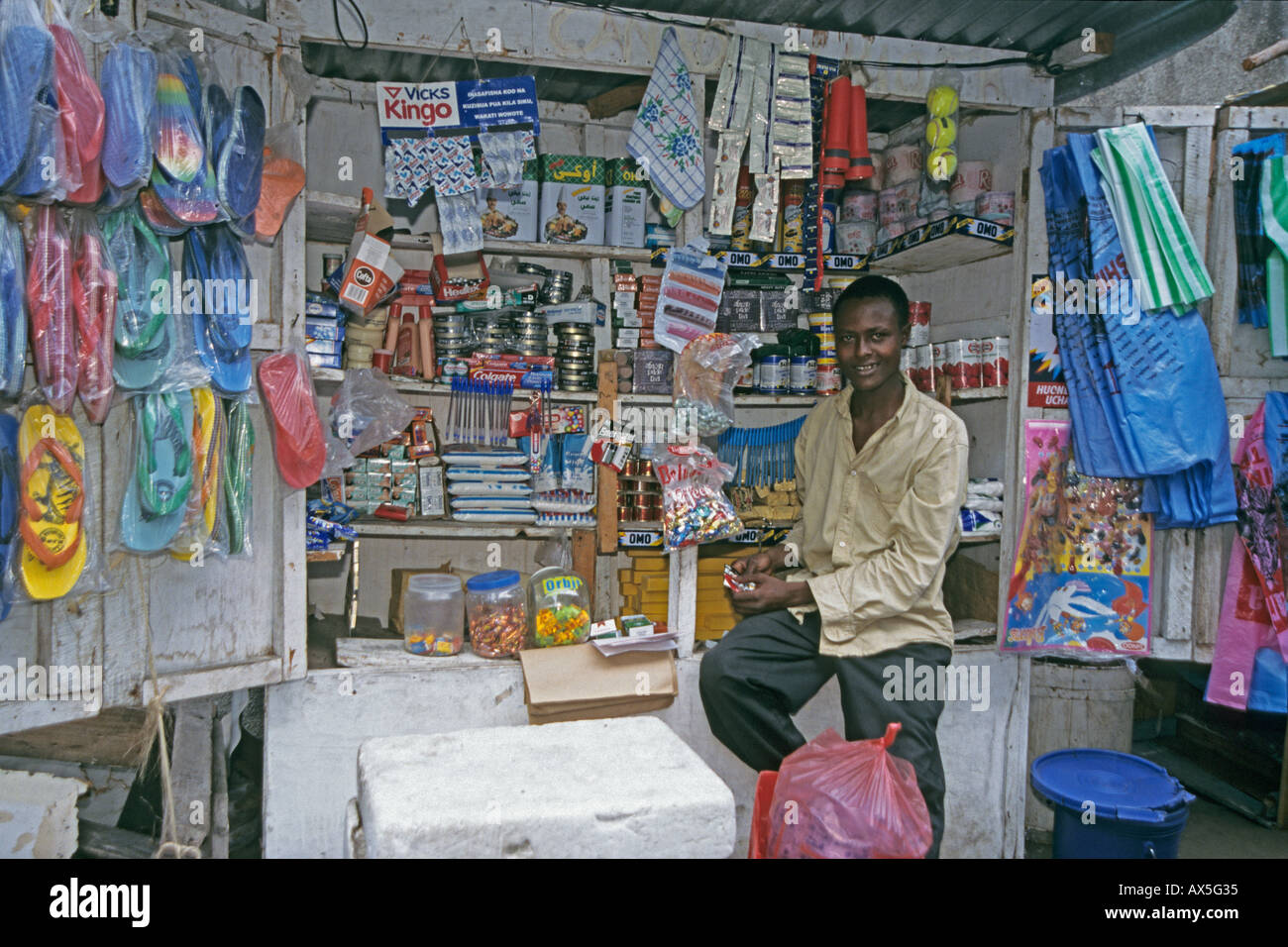 Young entrepreneur in his mobile kiosk, Moshi, Tanzania Stock Photo