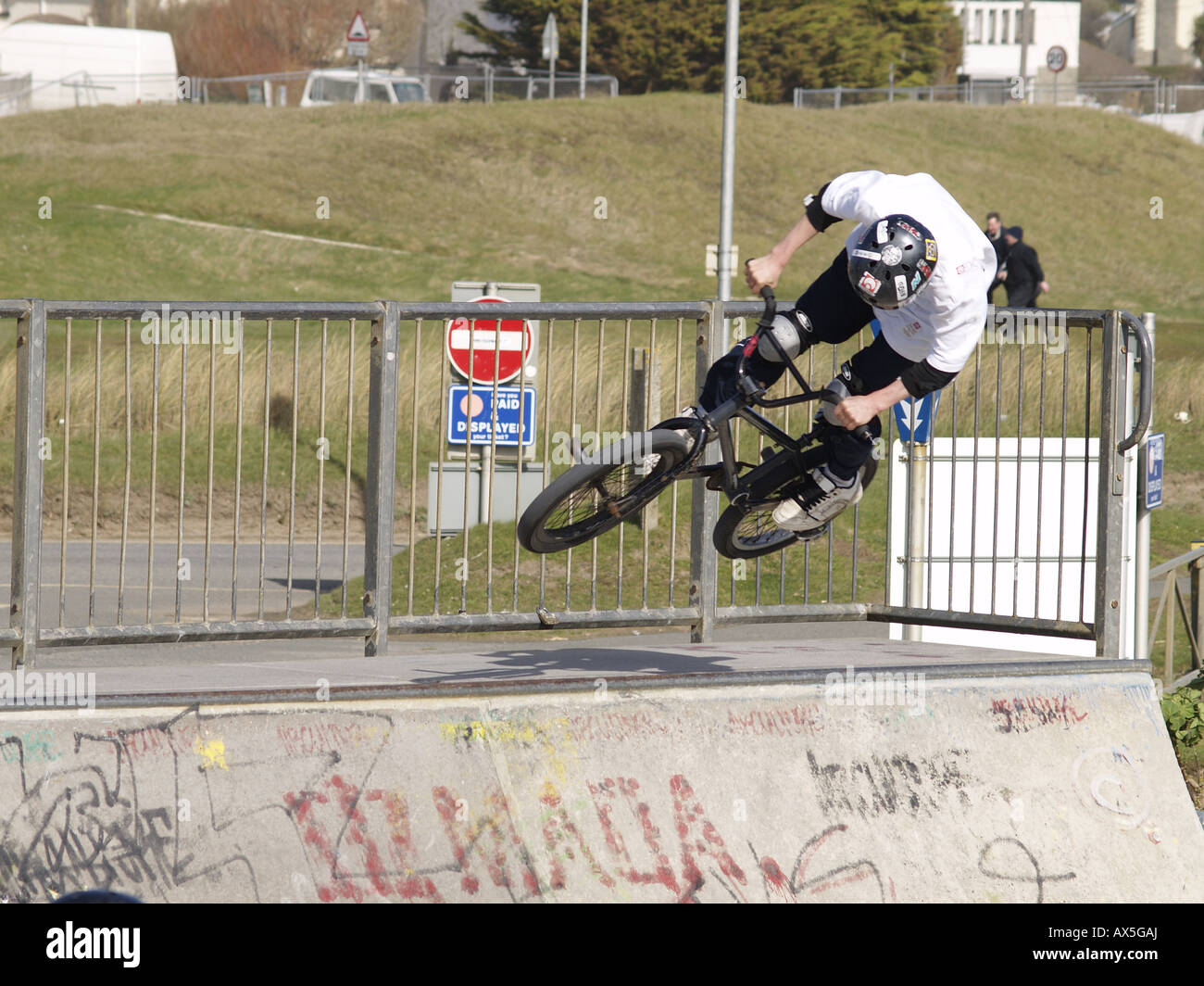 Teenage BMX rider on a half pipe in a skate park Stock Photo