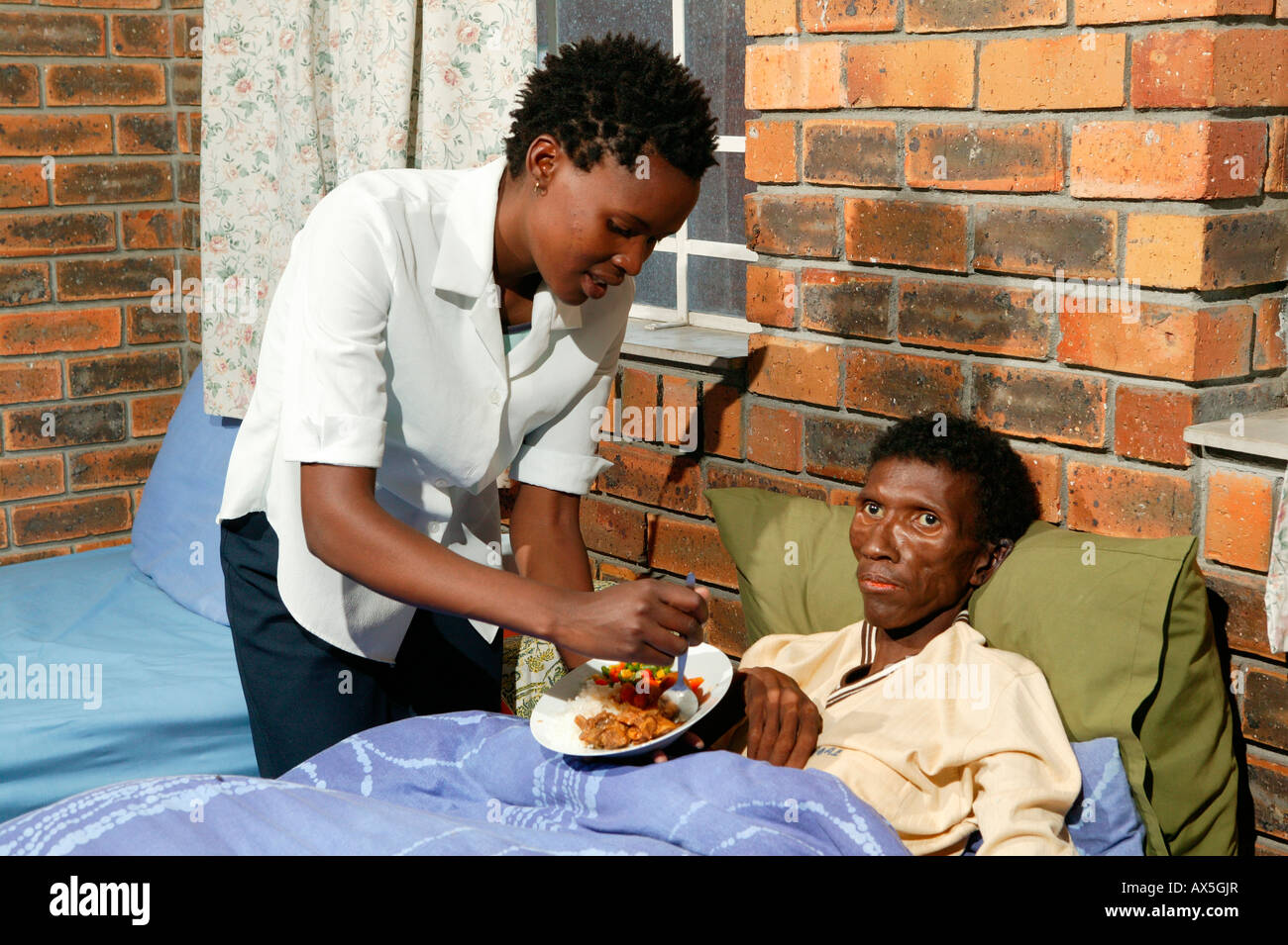 Nurse administering to a patient at a hospital for HIV/AIDS-infected patients in Capetown, South Africa, Africa Stock Photo