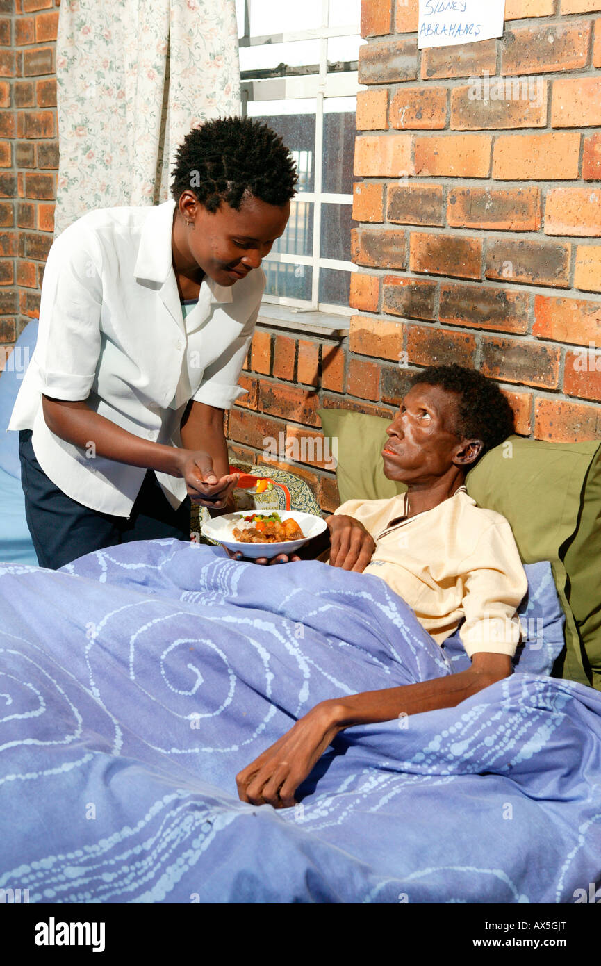 Nurse administering to a patient at a hospital for HIV/AIDSinfected