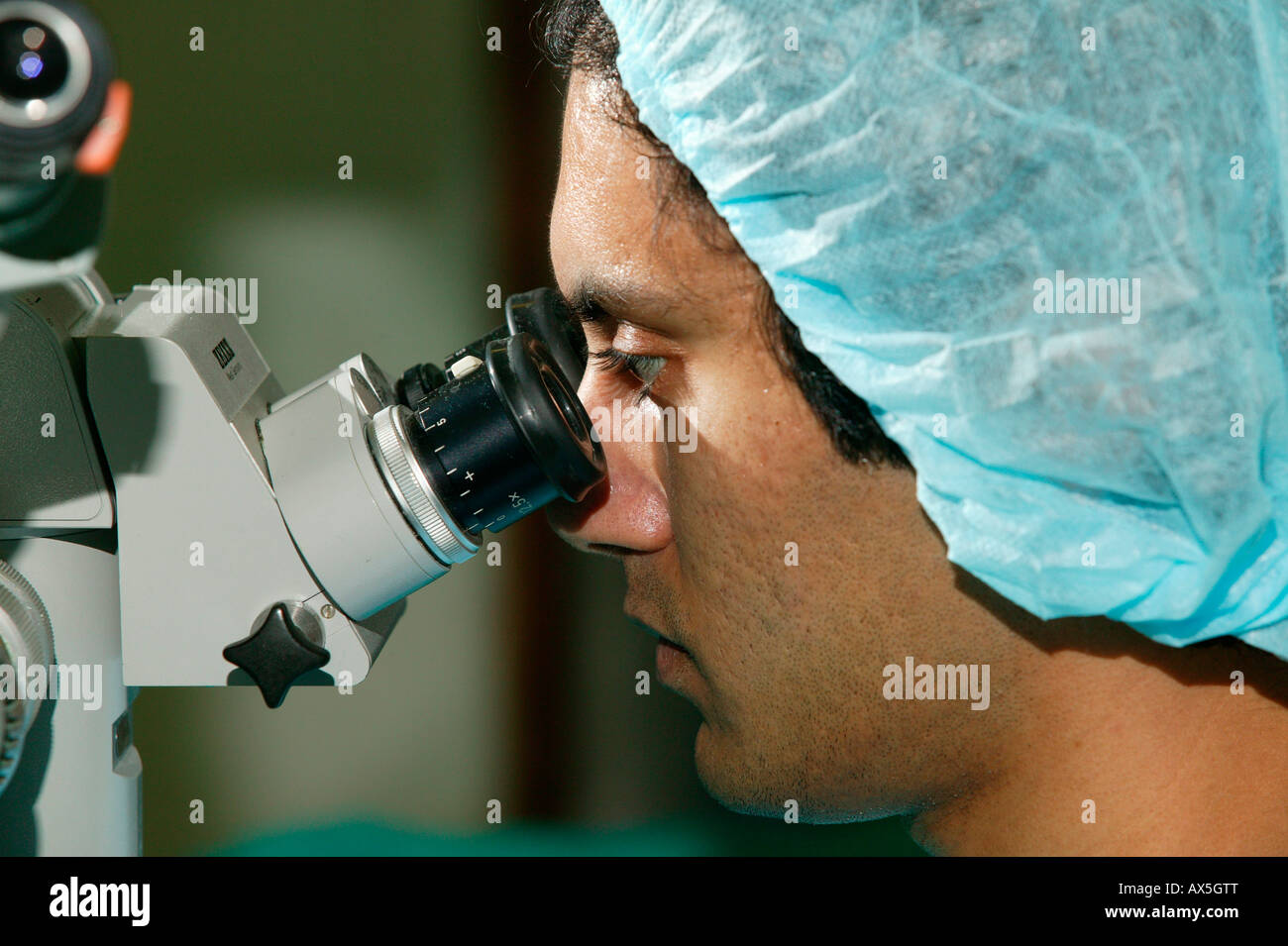 Physician looking through a microscope during cataract surgery in Pietermaritzburg, South Africa, Africa Stock Photo