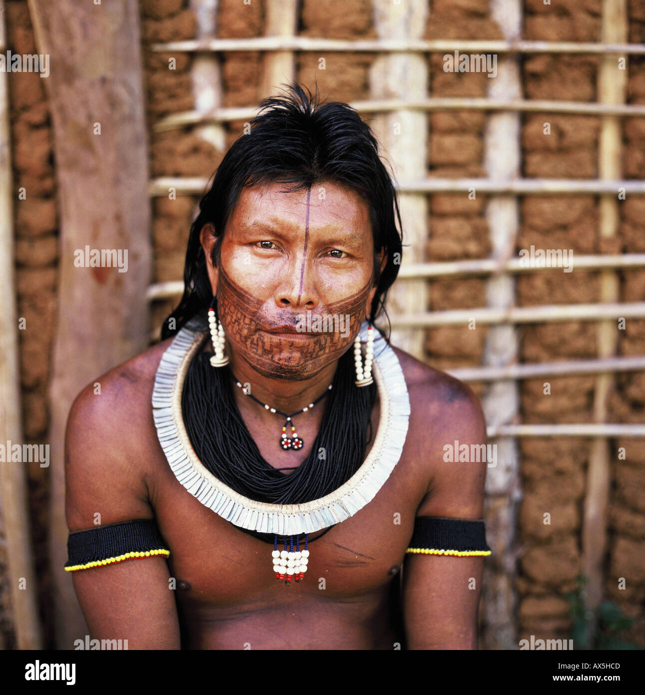A-Ukre Village, Xingu, Brazil. Krut, a Kayapo man, in front of a wattle and daub house. Stock Photo