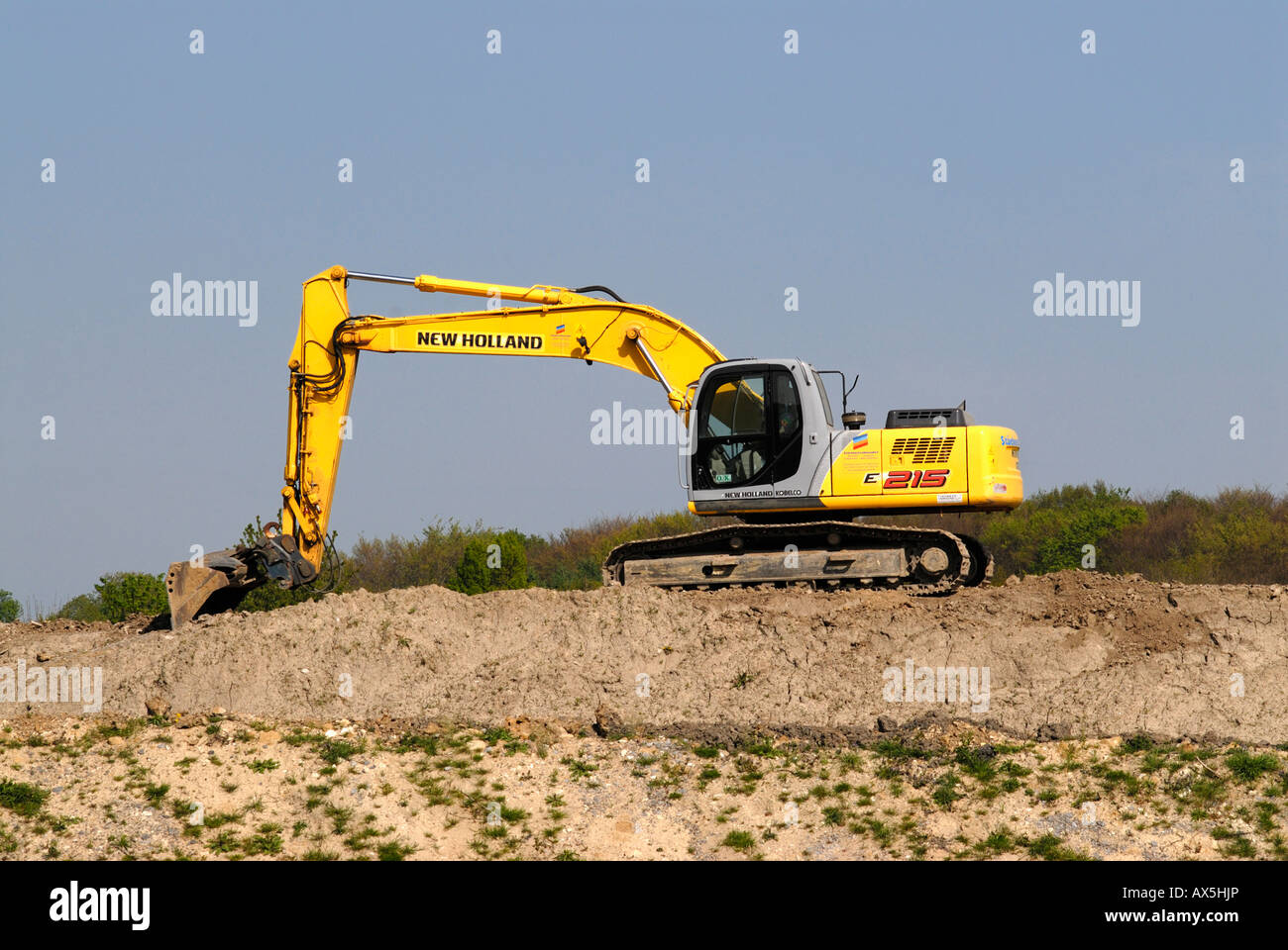Yellow excavator on a slope Stock Photo