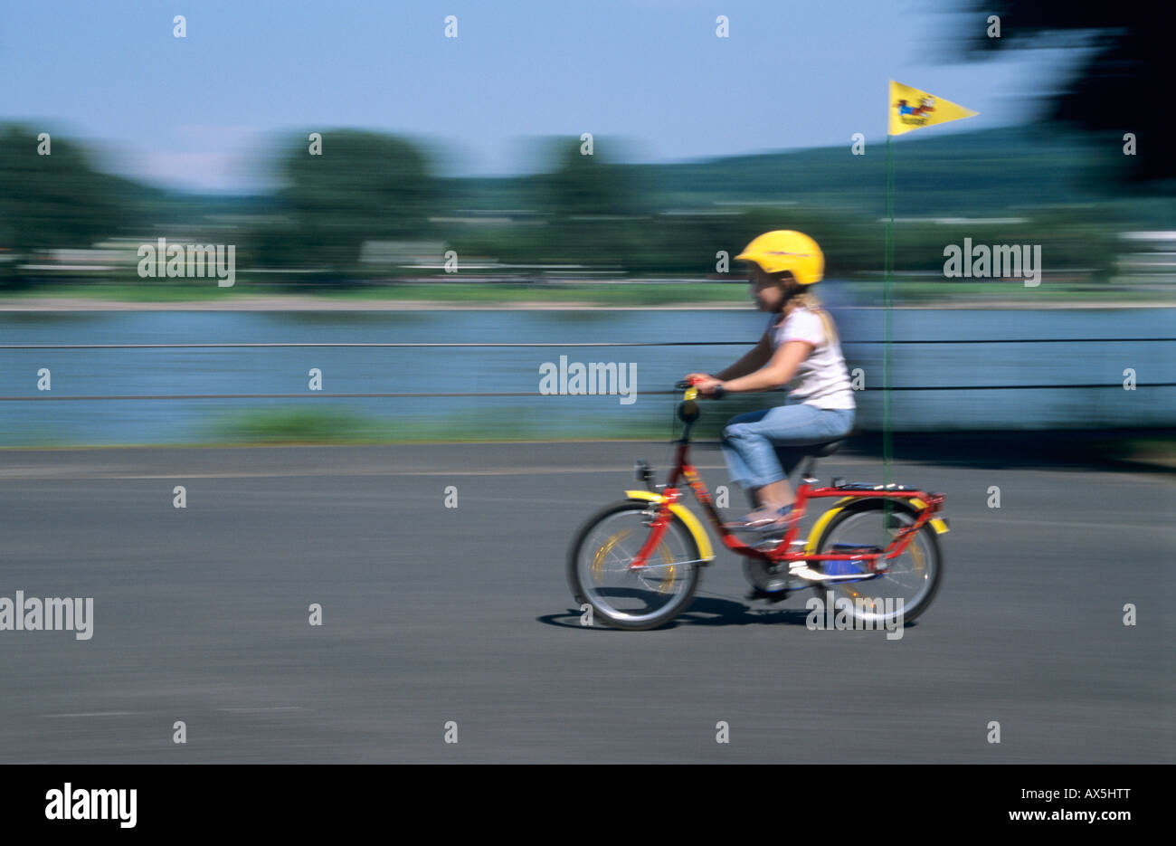 Girl wearing bicycle helmet riding a bicycle Stock Photo Alamy