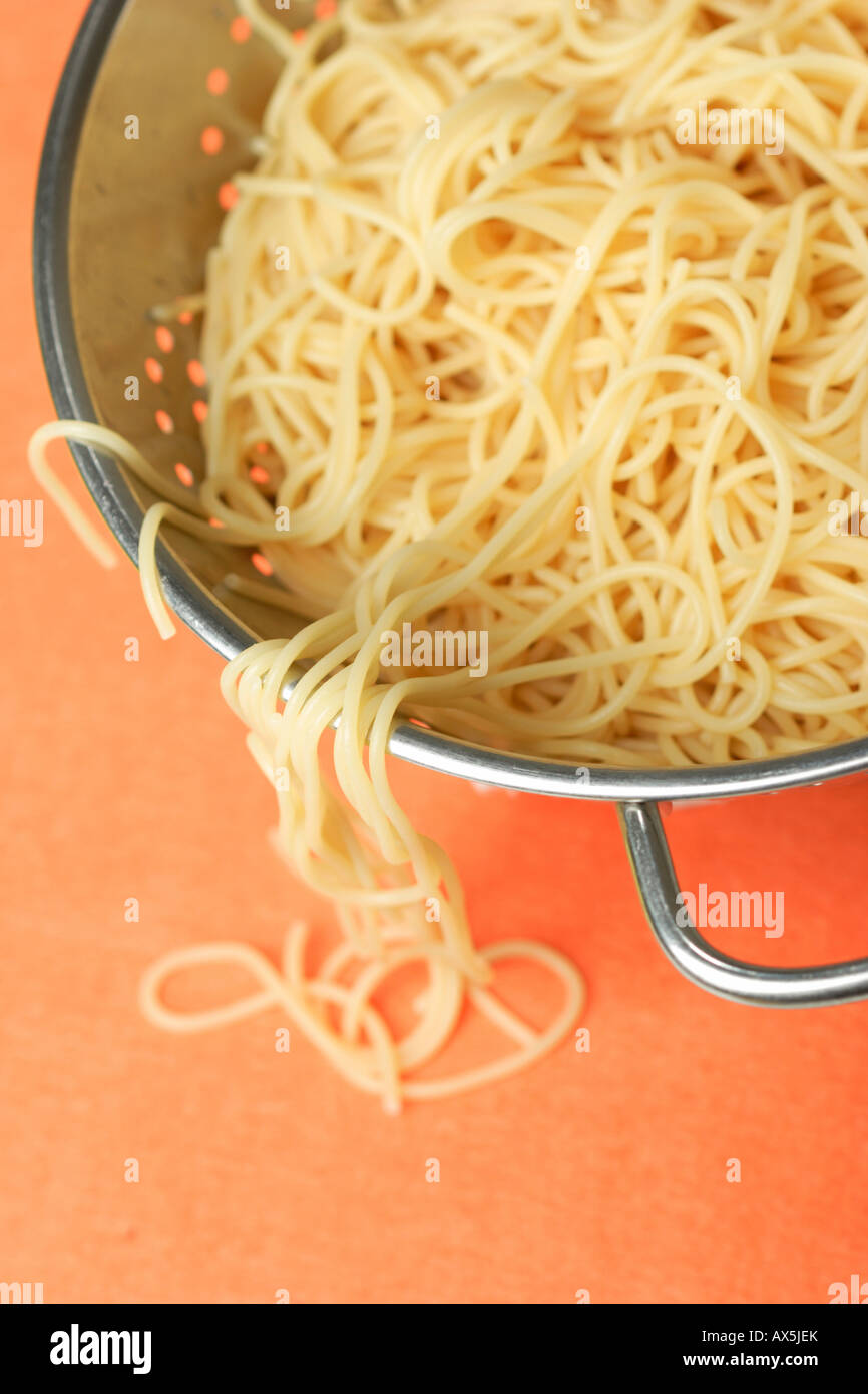 Cooked spaghetti in the sieve Stock Photo