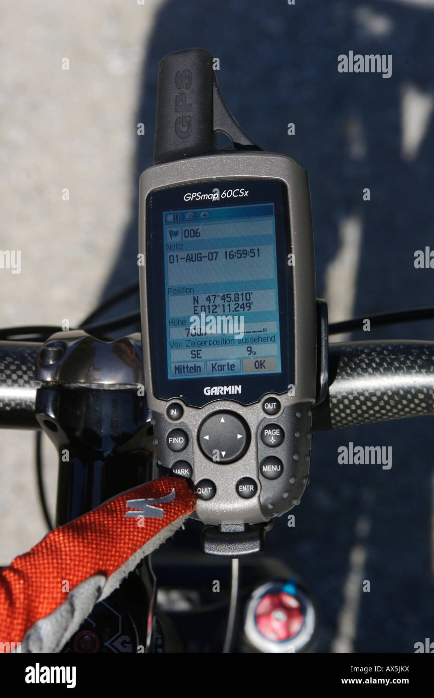 Mobile GPS unit on mountain bike handlebars, monitors showing