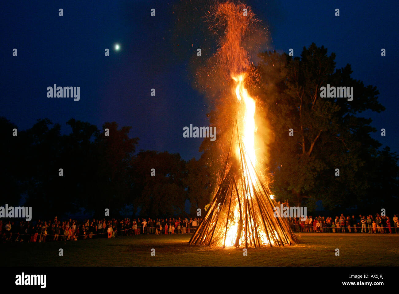 Midsummer bonfire against a night sky, moon Stock Photo