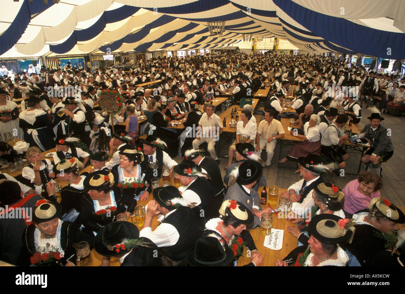 Attendees dressed in traditional costume sitting in the festival tent during the Loisachgau Festival in Egling, Upper Bavaria,  Stock Photo