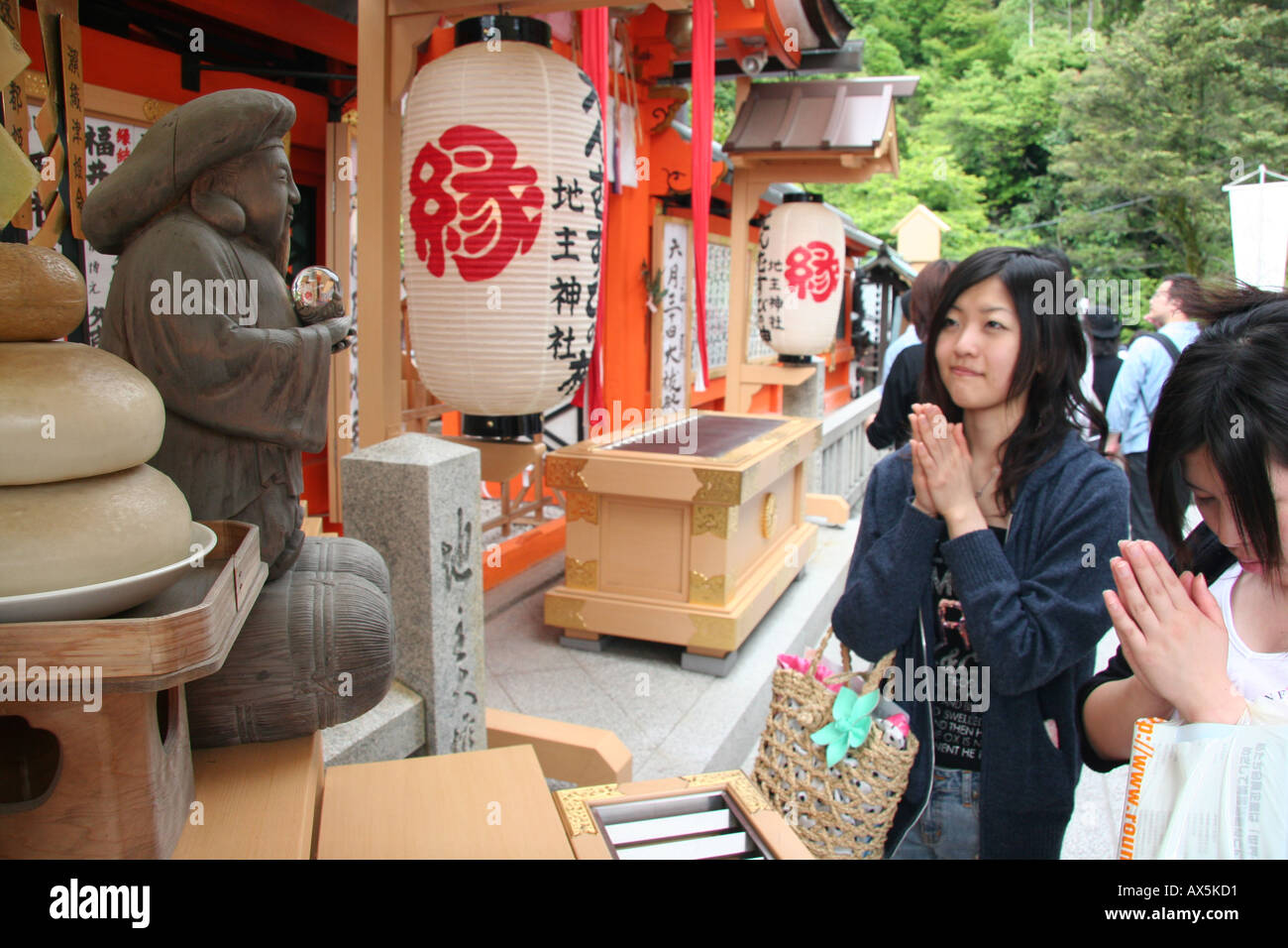 Women praying at a shinto shrine in Kyoto, Japan Stock Photo