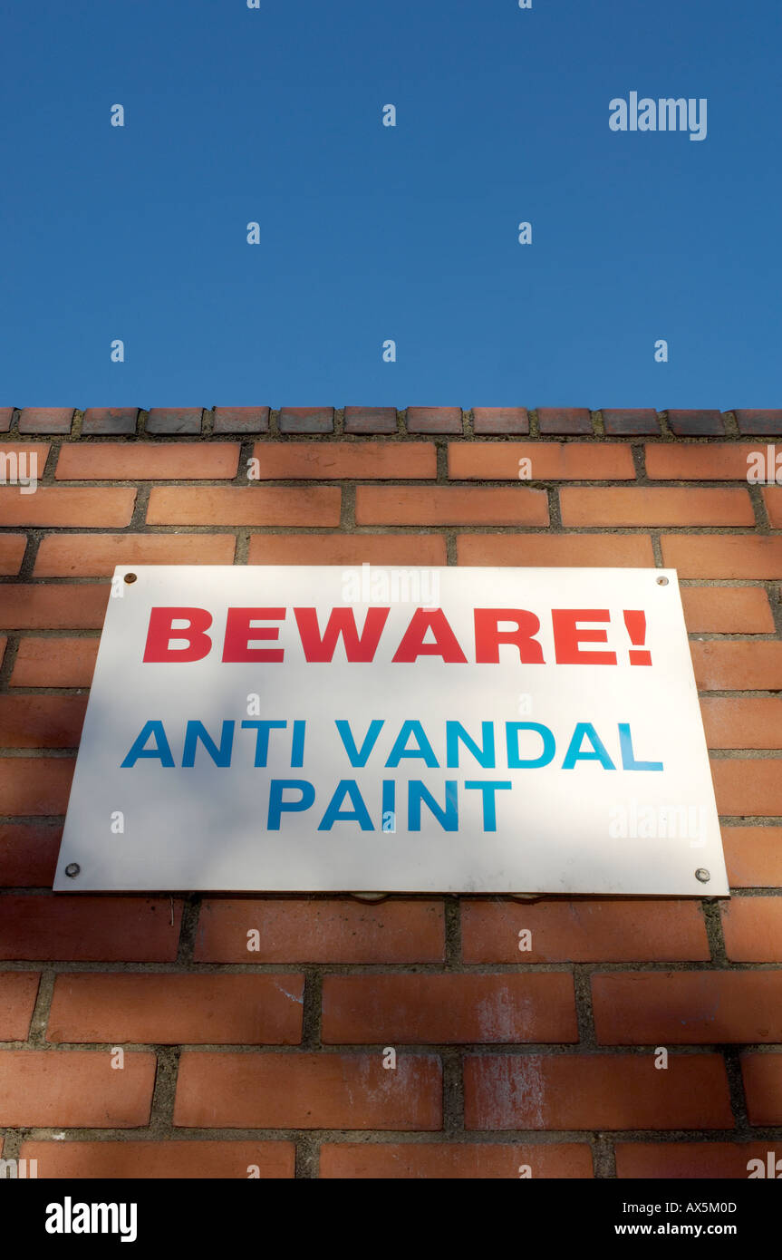 Beware Anti Vandal Paint sign mounted on a brick wall seen against a
