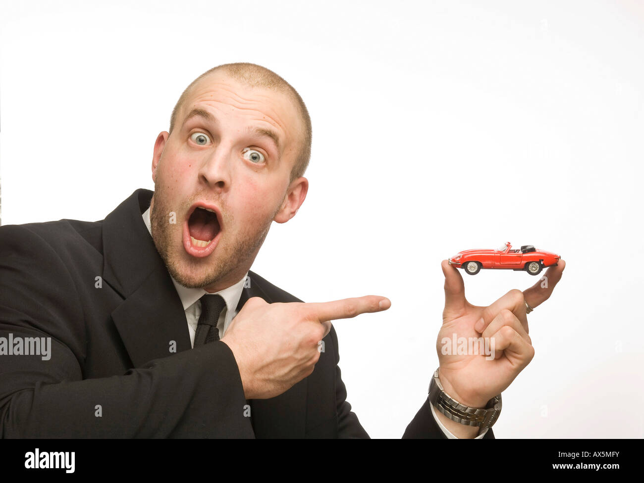 Young man holding model car Stock Photo