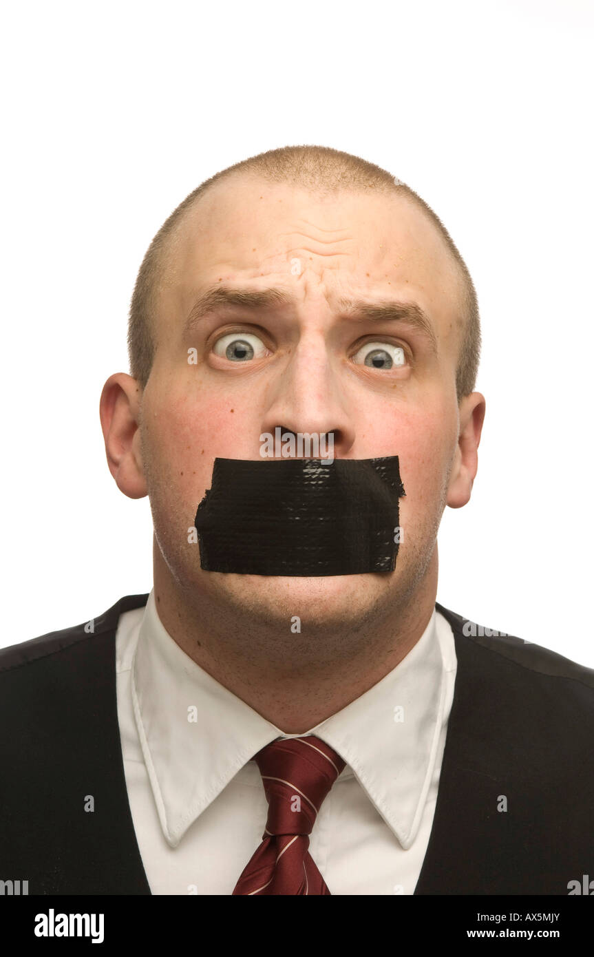 Young man with his mouth covered in masking tape Stock Photo - Alamy