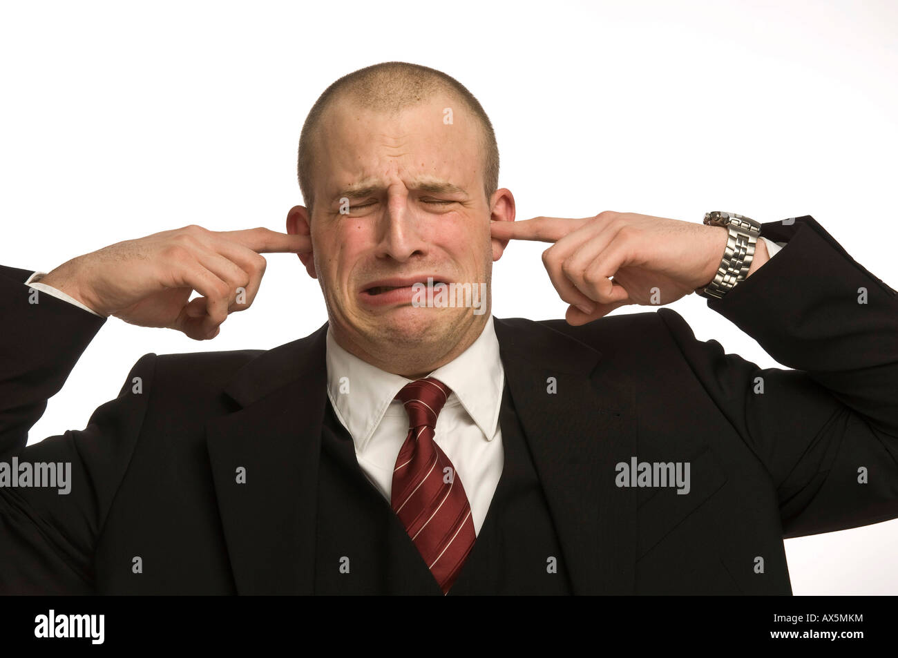 Young man plugging his ears Stock Photo