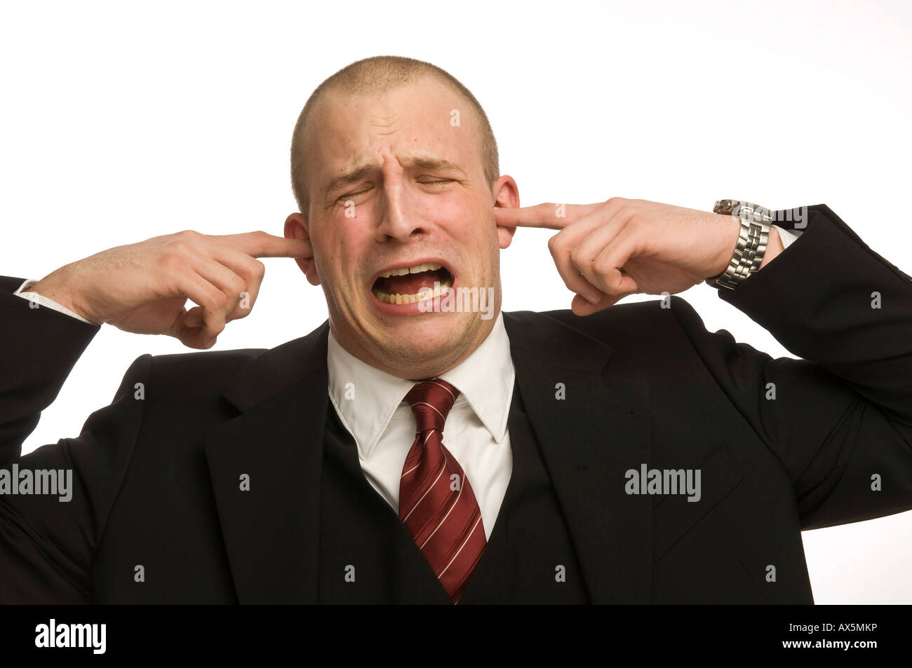 Young man plugging his ears Stock Photo