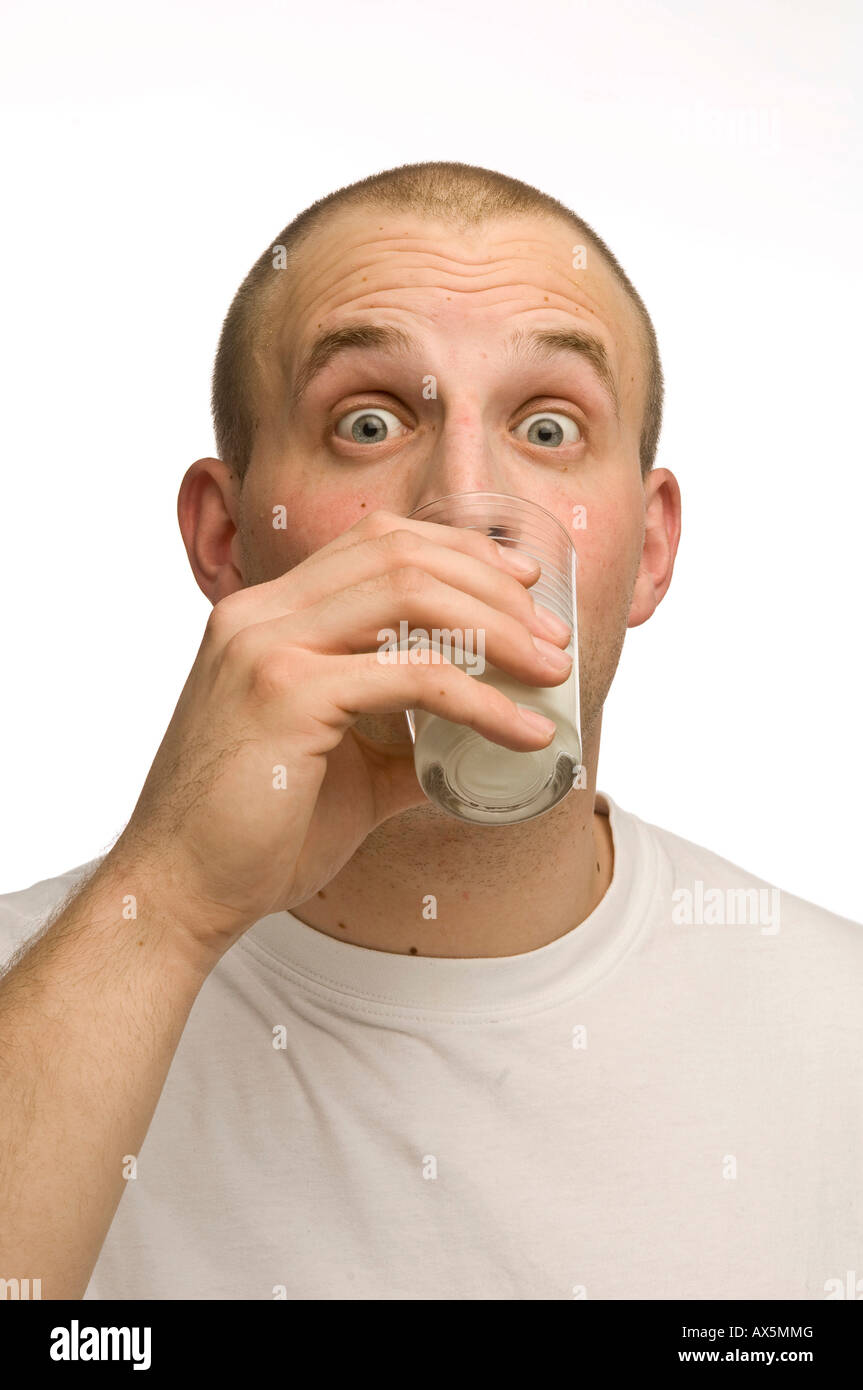 Young man drinking a glass of milk Stock Photo