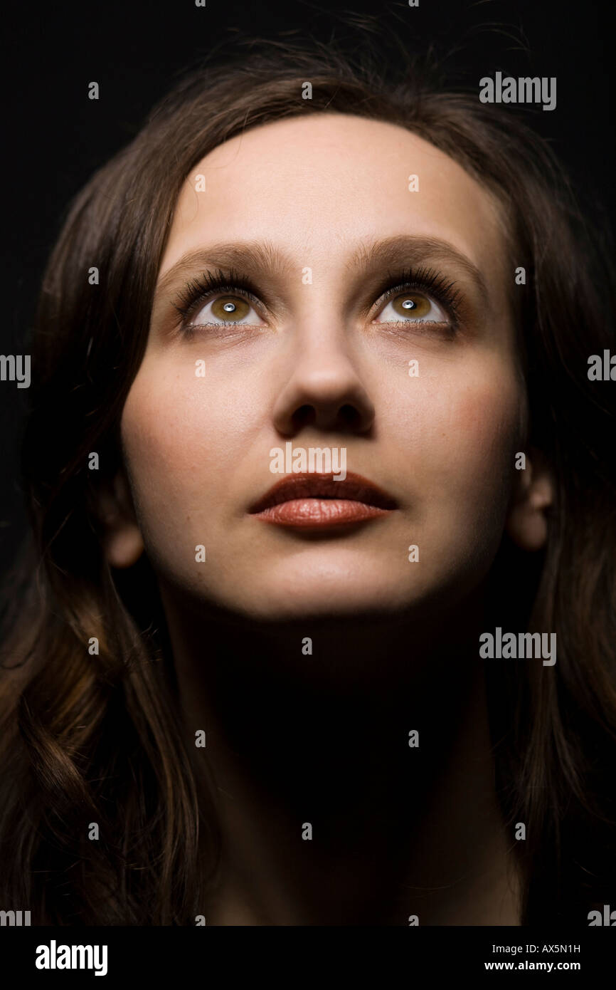 Portrait of a young woman, looking upward Stock Photo