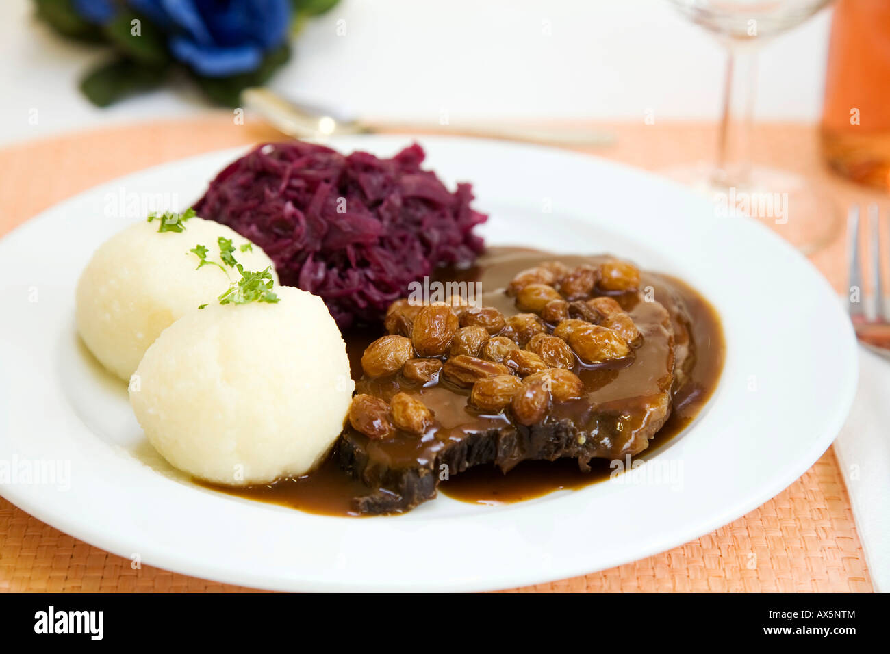 Rhenisch Sauerbraten (marinated beef roast) with potato dumplings and red cabbage Stock Photo