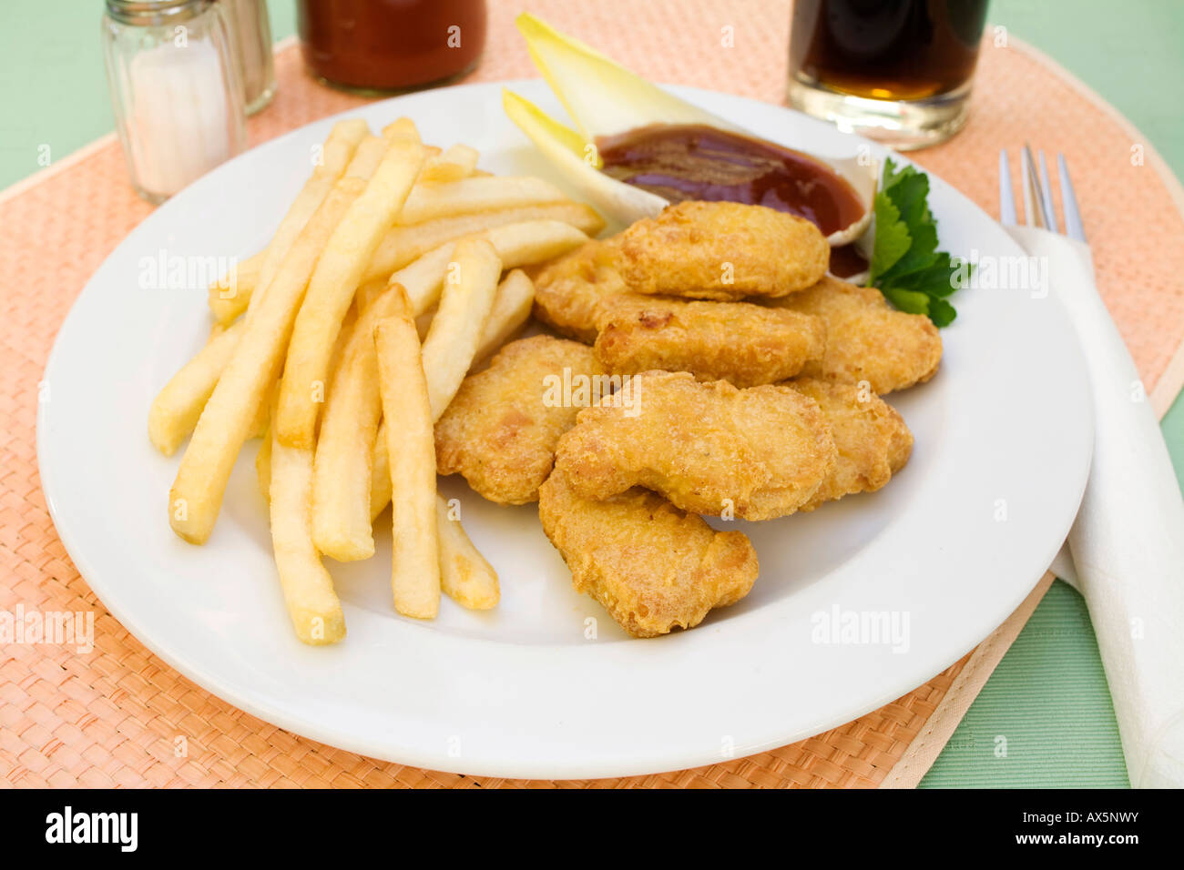 Chicken nuggets with barbecue sauce and chips Stock Photo